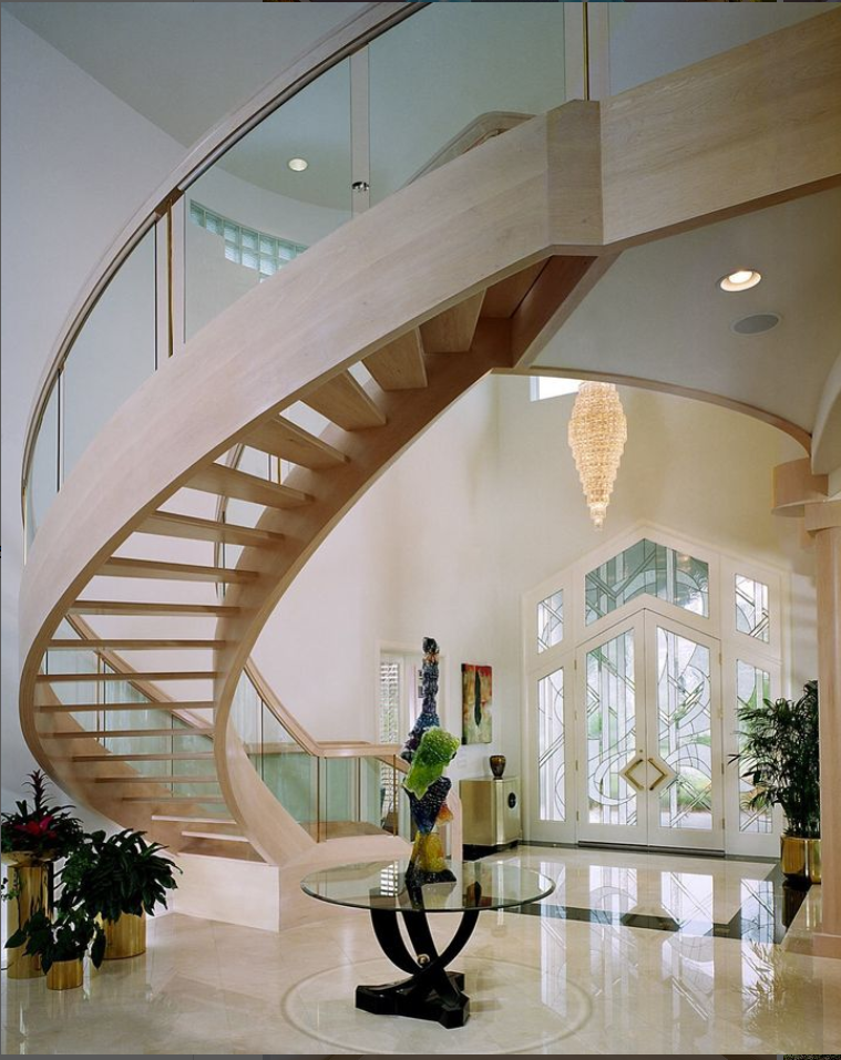 A spiral staircase is pictured inside a beautiful bright home